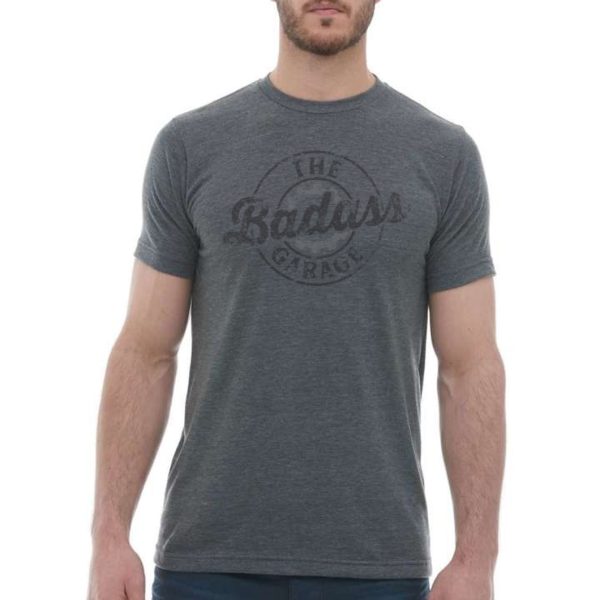 Man wearing dark grey biker t-shirt with The Badass Garage Logo in a distressed format on the front