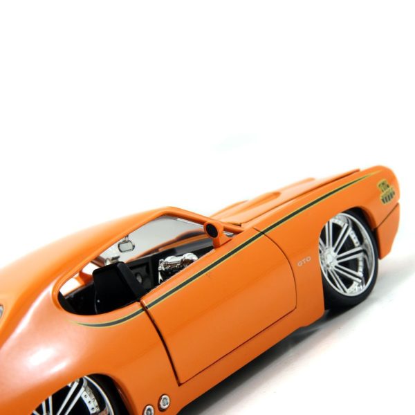 orange Diecast toy car in display box